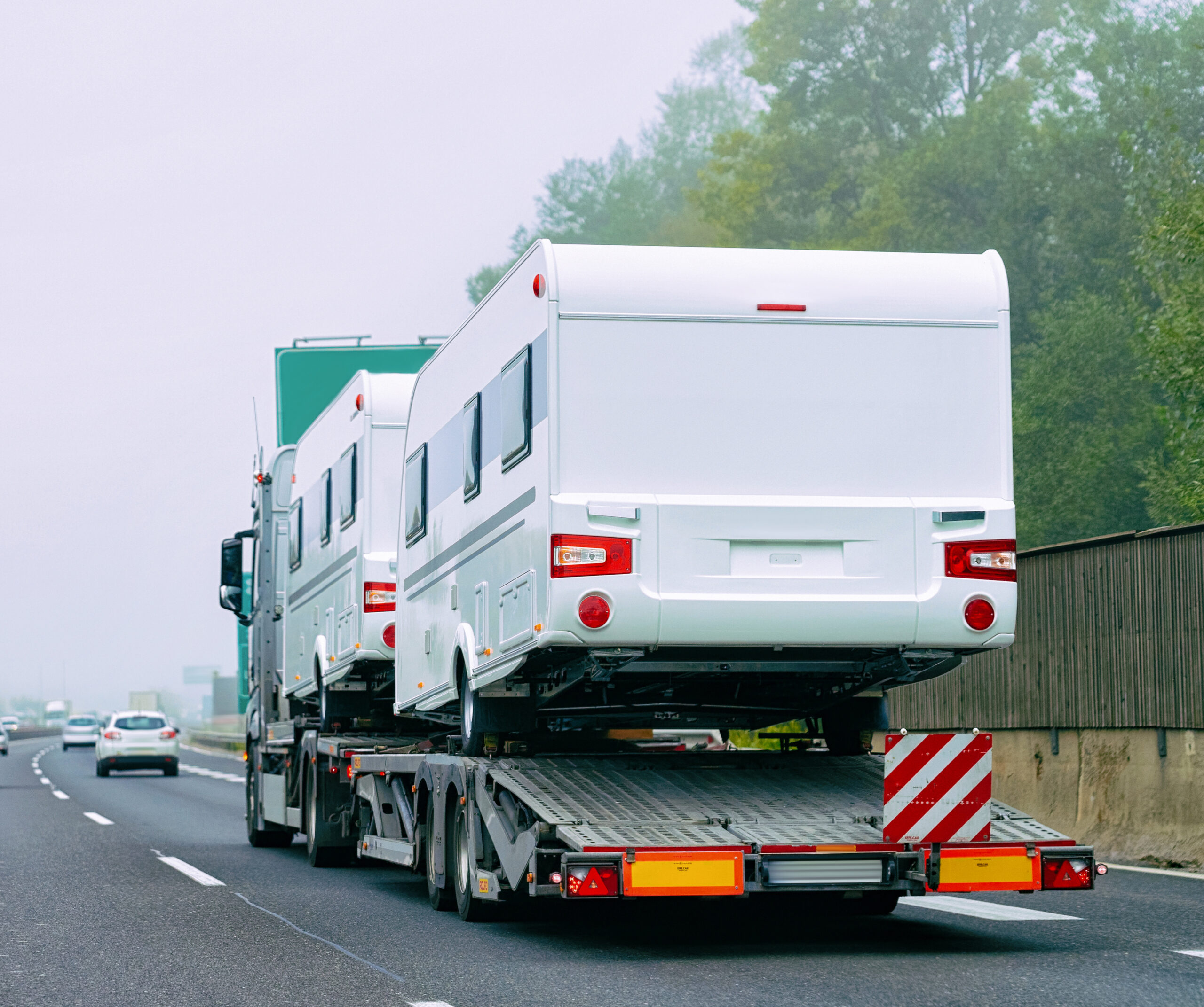 Truck transporting RVs on the highway